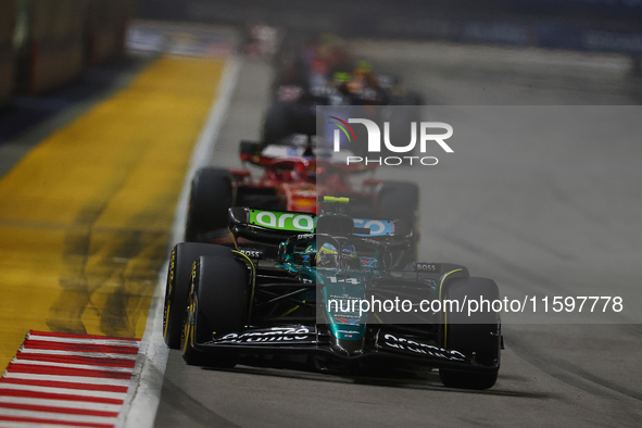 Fernando Alonso of Spain drives the Aston Martin Aramco F1 Team AMR24 during the F1 Grand Prix of Singapore at Marina Bay Street Circuit in...