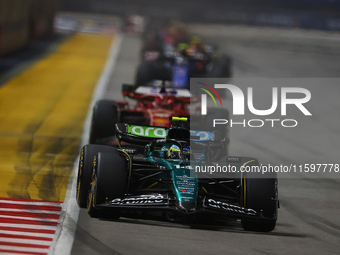 Fernando Alonso of Spain drives the Aston Martin Aramco F1 Team AMR24 during the F1 Grand Prix of Singapore at Marina Bay Street Circuit in...