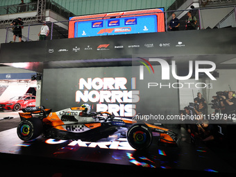 Lando Norris of the United Kingdom and McLaren Formula 1 Team celebrates victory during the F1 Grand Prix of Singapore at Marina Bay Street...