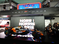 Lando Norris of the United Kingdom and McLaren Formula 1 Team celebrates victory during the F1 Grand Prix of Singapore at Marina Bay Street...