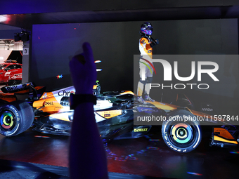 Lando Norris of the United Kingdom and McLaren Formula 1 Team celebrates victory during the F1 Grand Prix of Singapore at Marina Bay Street...