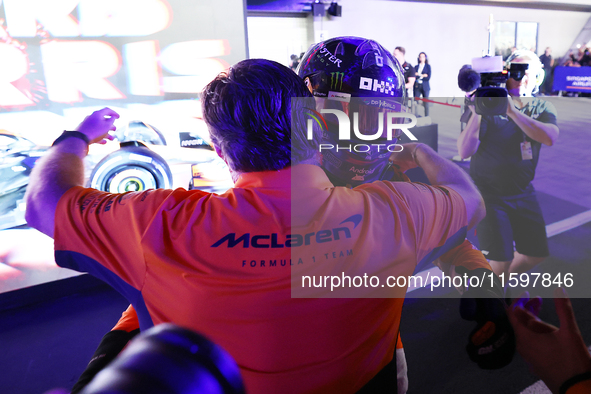 Lando Norris of the United Kingdom and the McLaren Formula 1 Team celebrates victory with Zak Brown during the F1 Grand Prix of Singapore at...