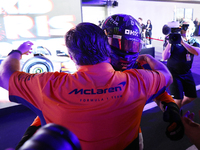 Lando Norris of the United Kingdom and the McLaren Formula 1 Team celebrates victory with Zak Brown during the F1 Grand Prix of Singapore at...