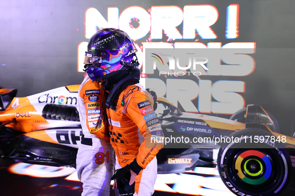 Oscar Piastri of Australia and the McLaren Formula 1 Team and Lando Norris of the United Kingdom and the McLaren Formula 1 Team embrace duri...