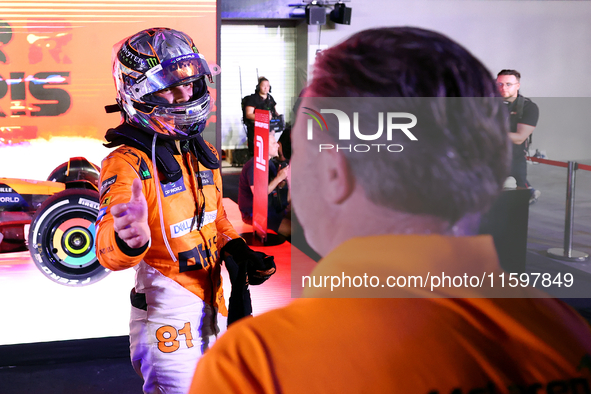 Oscar Piastri of Australia and the McLaren Formula 1 Team reacts with Zak Brown following the F1 Grand Prix of Singapore at Marina Bay Stree...