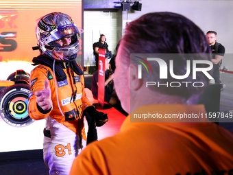 Oscar Piastri of Australia and the McLaren Formula 1 Team reacts with Zak Brown following the F1 Grand Prix of Singapore at Marina Bay Stree...