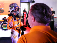 Oscar Piastri of Australia and the McLaren Formula 1 Team reacts with Zak Brown following the F1 Grand Prix of Singapore at Marina Bay Stree...