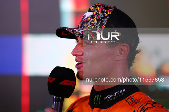 Lando Norris of the United Kingdom and McLaren Formula 1 Team celebrates winning the F1 Grand Prix of Singapore at Marina Bay Street Circuit...