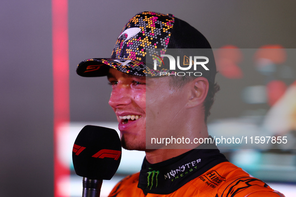 Lando Norris of the United Kingdom and McLaren Formula 1 Team celebrates winning the F1 Grand Prix of Singapore at Marina Bay Street Circuit...