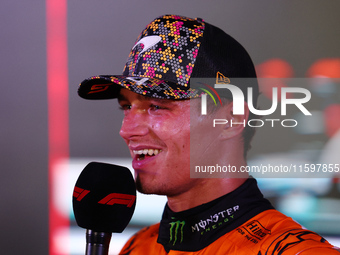 Lando Norris of the United Kingdom and McLaren Formula 1 Team celebrates winning the F1 Grand Prix of Singapore at Marina Bay Street Circuit...