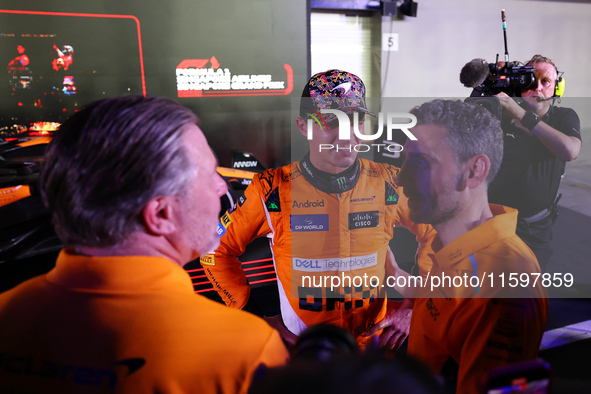 Zak Brown, CEO of McLaren Racing, and Andrea Stella, Team Principal of McLaren F1 Team, chat with Lando Norris of the United Kingdom and McL...