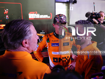 Zak Brown, CEO of McLaren Racing, and Andrea Stella, Team Principal of McLaren F1 Team, chat with Lando Norris of the United Kingdom and McL...