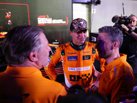 Zak Brown, CEO of McLaren Racing, and Andrea Stella, Team Principal of McLaren F1 Team, chat with Lando Norris of the United Kingdom and McL...