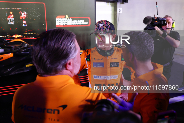 Zak Brown, CEO of McLaren Racing, and Andrea Stella, Team Principal of McLaren F1 Team, chat with Lando Norris of the United Kingdom and McL...