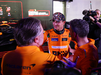 Zak Brown, CEO of McLaren Racing, and Andrea Stella, Team Principal of McLaren F1 Team, chat with Lando Norris of the United Kingdom and McL...