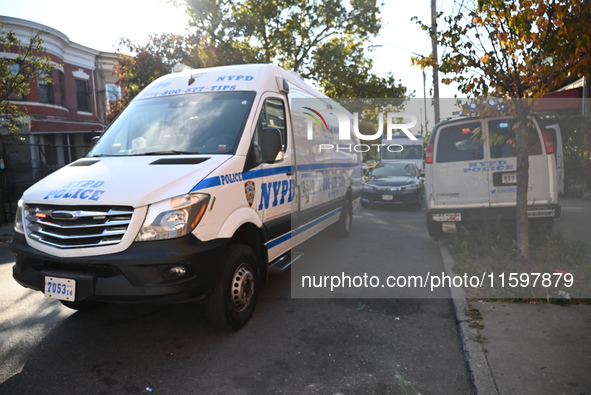 NYPD crime scene investigators search and mark evidence after a 42-year-old man is killed by gunshots to the shoulder and arm in the East Ne...