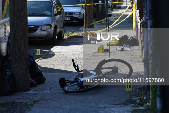 NYPD crime scene investigators search and mark evidence after a 42-year-old man is killed by gunshots to the shoulder and arm in the East Ne...