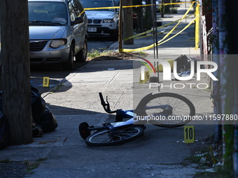 NYPD crime scene investigators search and mark evidence after a 42-year-old man is killed by gunshots to the shoulder and arm in the East Ne...