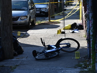 NYPD crime scene investigators search and mark evidence after a 42-year-old man is killed by gunshots to the shoulder and arm in the East Ne...