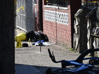 NYPD crime scene investigators search and mark evidence after a 42-year-old man is killed by gunshots to the shoulder and arm in the East Ne...