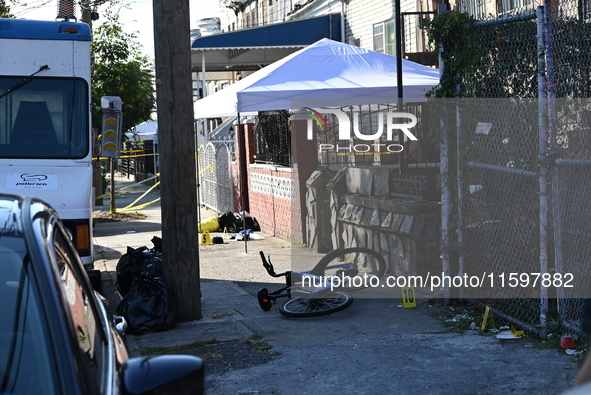 NYPD crime scene investigators search and mark evidence after a 42-year-old man is killed by gunshots to the shoulder and arm in the East Ne...