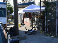 NYPD crime scene investigators search and mark evidence after a 42-year-old man is killed by gunshots to the shoulder and arm in the East Ne...