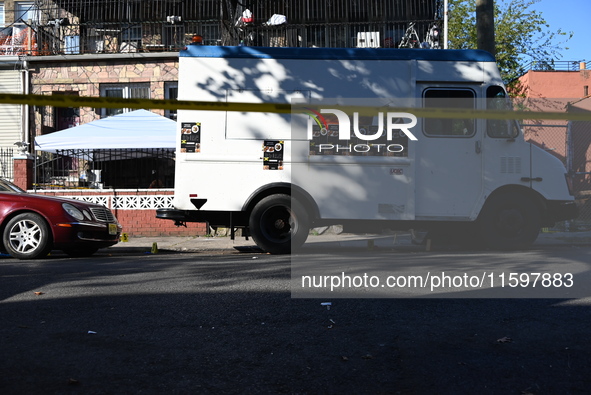 NYPD crime scene investigators search and mark evidence after a 42-year-old man is killed by gunshots to the shoulder and arm in the East Ne...