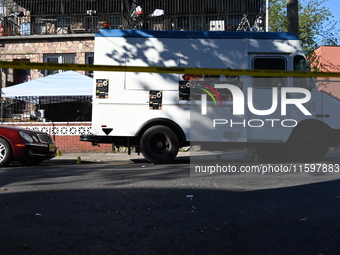 NYPD crime scene investigators search and mark evidence after a 42-year-old man is killed by gunshots to the shoulder and arm in the East Ne...