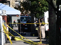 NYPD crime scene investigators search and mark evidence after a 42-year-old man is killed by gunshots to the shoulder and arm in the East Ne...