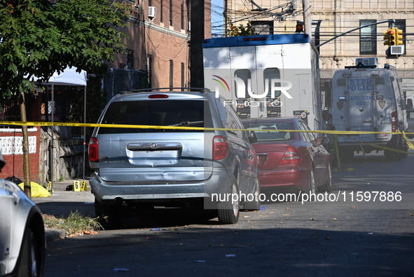 NYPD crime scene investigators search and mark evidence after a 42-year-old man is killed by gunshots to the shoulder and arm in the East Ne...