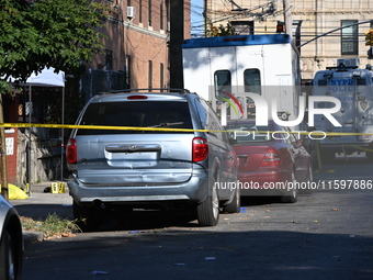 NYPD crime scene investigators search and mark evidence after a 42-year-old man is killed by gunshots to the shoulder and arm in the East Ne...