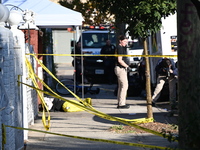 NYPD crime scene investigators search and mark evidence after a 42-year-old man is killed by gunshots to the shoulder and arm in the East Ne...