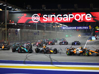 Lando Norris of the United Kingdom and McLaren Formula 1 Team, Max Verstappen of the Netherlands and Red Bull Racing-Honda RBPT, and Lewis H...