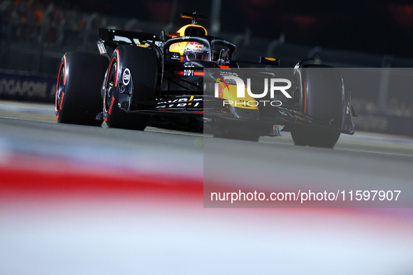 Max Verstappen of the Netherlands and Red Bull Racing-Honda RBPT drives to the grid ahead of the F1 Grand Prix of Singapore at Marina Bay St...