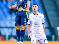 Angelino of AS Roma and Lorenzo Lucca of Udinese Calcio during the Serie A Enilive match between AS Roma and Udinese Calcio at Stadio Olimpi...