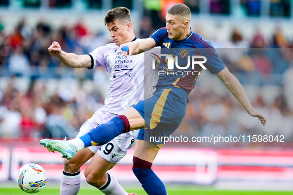 Artem Dovbyk of AS Roma and Jaka Bijol of Udinese Calcio compete for the ball during the Serie A Enilive match between AS Roma and Udinese C...