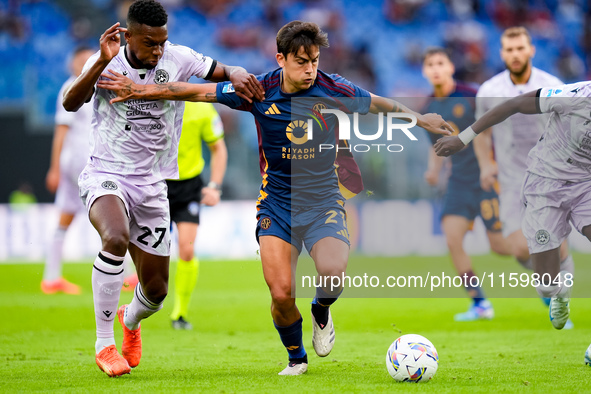 Paulo Dybala of AS Roma and Christian Kabasele of Udinese Calcio compete for the ball during the Serie A Enilive match between AS Roma and U...