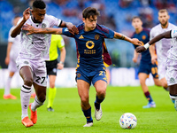 Paulo Dybala of AS Roma and Christian Kabasele of Udinese Calcio compete for the ball during the Serie A Enilive match between AS Roma and U...