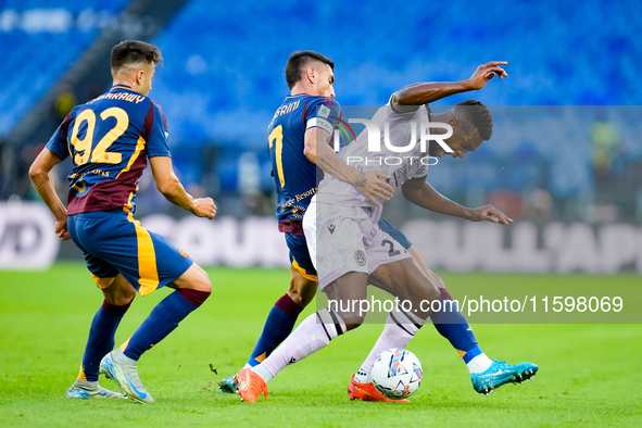 Christian Kabasele of Udinese Calcio and Lorenzo Pellegrini of AS Roma compete for the ball during the Serie A Enilive match between AS Roma...