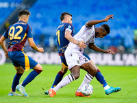 Christian Kabasele of Udinese Calcio and Lorenzo Pellegrini of AS Roma compete for the ball during the Serie A Enilive match between AS Roma...