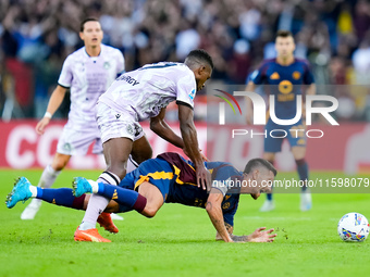 Christian Kabasele of Udinese Calcio and Lorenzo Pellegrini of AS Roma compete for the ball during the Serie A Enilive match between AS Roma...