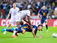 Christian Kabasele of Udinese Calcio and Lorenzo Pellegrini of AS Roma compete for the ball during the Serie A Enilive match between AS Roma...