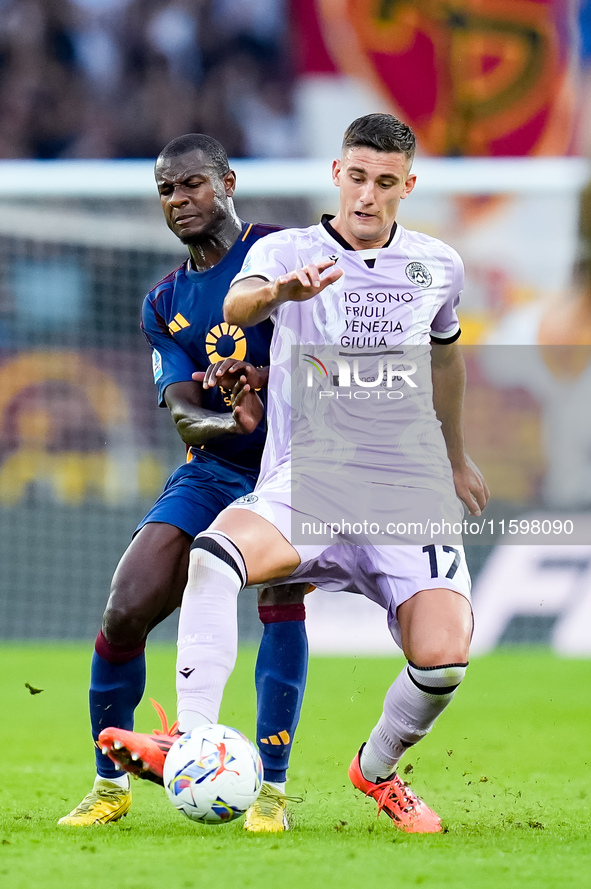 Lorenzo Lucca of Udinese Calcio and Evan Ndicka of AS Roma compete for the ball during the Serie A Enilive match between AS Roma and Udinese...