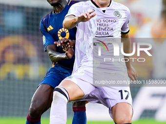 Lorenzo Lucca of Udinese Calcio and Evan Ndicka of AS Roma compete for the ball during the Serie A Enilive match between AS Roma and Udinese...