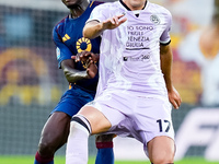 Lorenzo Lucca of Udinese Calcio and Evan Ndicka of AS Roma compete for the ball during the Serie A Enilive match between AS Roma and Udinese...