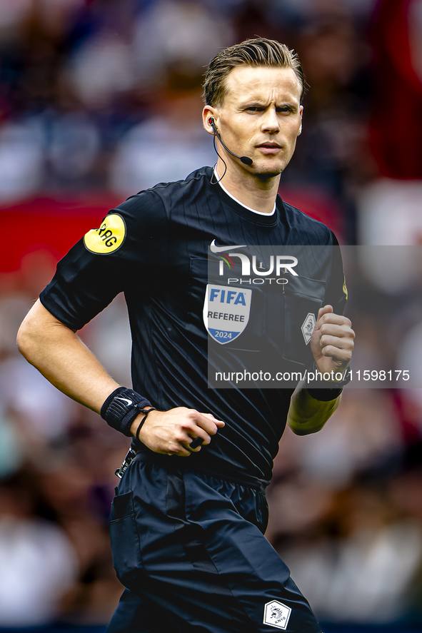 Referee Sander van der Eijk officiates the match between Feyenoord and NAC at Stadium De Kuip for the Dutch Eredivisie season 2024-2025 in R...