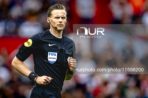 Referee Sander van der Eijk officiates the match between Feyenoord and NAC at Stadium De Kuip for the Dutch Eredivisie season 2024-2025 in R...