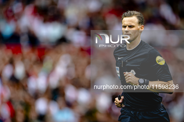 Referee Sander van der Eijk officiates the match between Feyenoord and NAC at Stadium De Kuip for the Dutch Eredivisie season 2024-2025 in R...