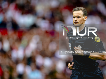 Referee Sander van der Eijk officiates the match between Feyenoord and NAC at Stadium De Kuip for the Dutch Eredivisie season 2024-2025 in R...