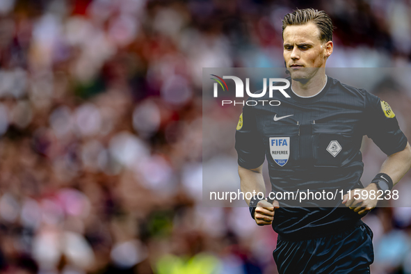 Referee Sander van der Eijk officiates the match between Feyenoord and NAC at Stadium De Kuip for the Dutch Eredivisie season 2024-2025 in R...